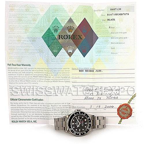 The image shows a frontal view of a Rolex GMT-Master 16710 Men's Stainless Steel Black Dial 16710 Men's Stainless Steel Black Dial watch placed in front of its certificate of authenticity and warranty.