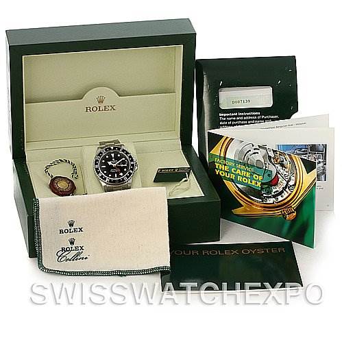 The image shows the Rolex GMT-Master 16710 Men's Stainless Steel Black Dial 16710 Men's Stainless Steel Black Dial watch with its original box, tag, warranty card, booklet, and cleaning cloth.