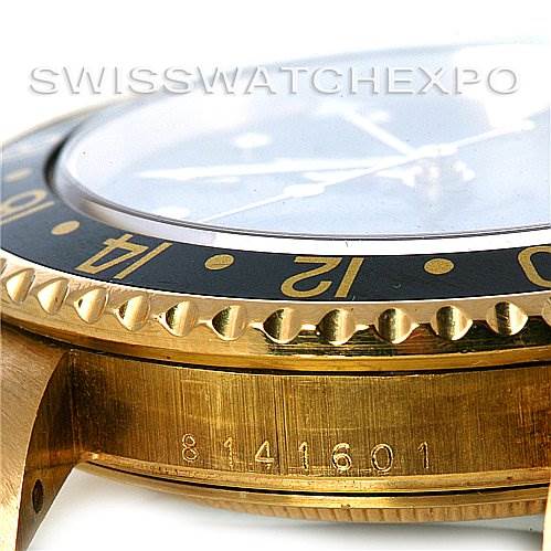 The image shows a side angle of the Rolex GMT-Master 16758 Men's Stainless Steel Black Dial 16758 Men's Stainless Steel Black Dial's gold and black bezel, case, and part of the serial number.