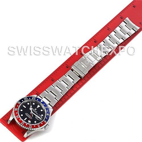 The Rolex GMT-Master 16710 Men's Stainless Steel Black Dial 16710 Men's Stainless Steel Black Dial watch is shown from a top-down angle, alongside a red ruler for size reference.