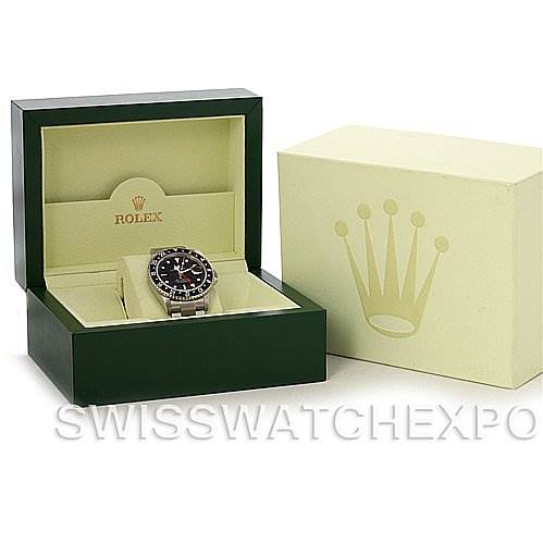 The image shows a Rolex GMT-Master 16710 T Men's Stainless Steel Black Dial 16710 T Men's Stainless Steel Black Dial watch in an oblique view with its open green presentation box and a separate outer box.