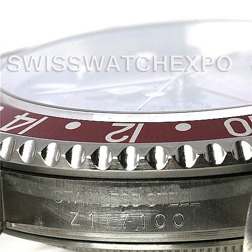 This image shows a close-up angle of the side of a Rolex GMT-Master 16710 Men's Stainless Steel Black Dial 16710 Men's Stainless Steel Black Dial watch, highlighting the red bezel and stainless steel case with engravings.