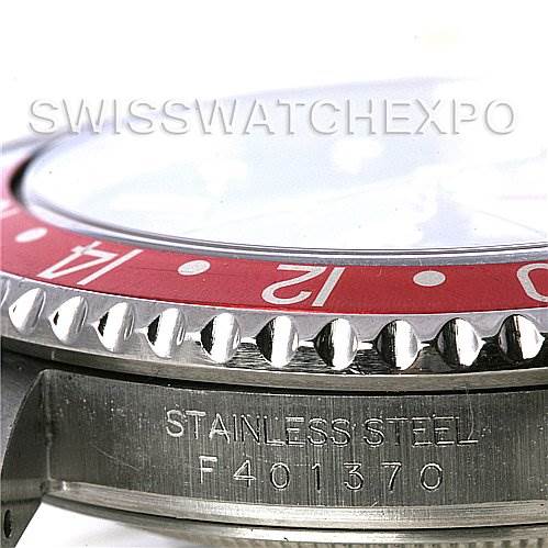 The image shows a side view of the bezel and part of the case of a Rolex GMT-Master 16710 Men's Stainless Steel Black Dial 16710 Men's Stainless Steel Black Dial watch, including the serial number and stainless steel engravings.
