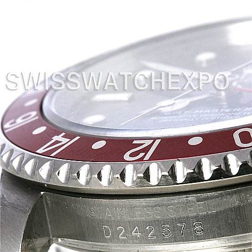 This image shows a close-up of the bezel and part of the case of a Rolex GMT-Master 16710 Men's Stainless Steel Black Dial 16710 Men's Stainless Steel Black Dial watch, highlighting the serial number and stainless steel engraving.