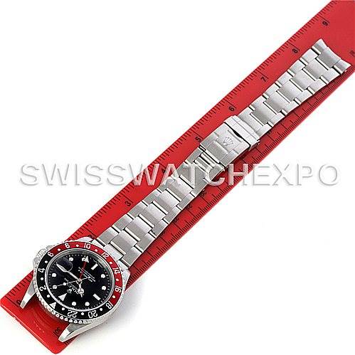 The image shows a Rolex GMT-Master 16710 Men's Stainless Steel Black Dial 16710 Men's Stainless Steel Black Dial watch laid flat on a red ruler, displaying its bracelet and bezel.
