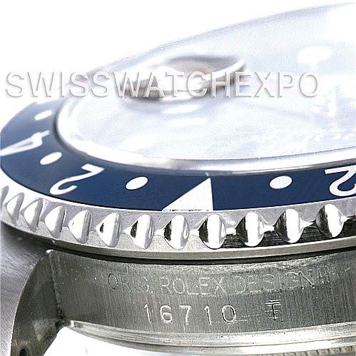 The image shows a close-up angled view of the bezel, crown, and design engraving of a Rolex GMT-Master 16710 Men's Stainless Steel Black Dial 16710 Men's Stainless Steel Black Dial model 16710.