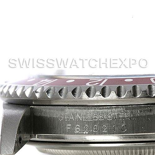 This image shows a close-up side view of the bezel and case of a Rolex GMT-Master 16710 Men's Stainless Steel Black Dial 16710 Men's Stainless Steel Black Dial watch, highlighting the serial number and "stainless steel" engraving.