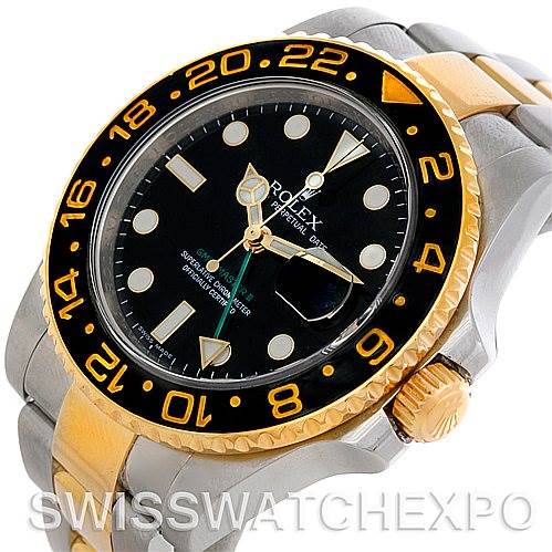 The image shows a Rolex GMT-Master 116713 Men's Stainless Steel Black Dial 116713 Men's Stainless Steel Black Dial watch from a high-side angle, featuring a black dial, gold and silver bracelet, and a black bezel with gold markings.