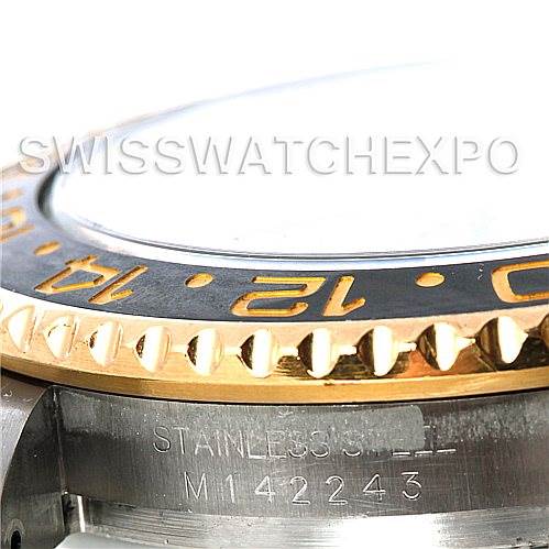 This image shows a close-up of the side of a Rolex GMT-Master 116713 Men's Stainless Steel Black Dial 116713 Men's Stainless Steel Black Dial watch, focusing on the bezel and part of the stainless steel case.