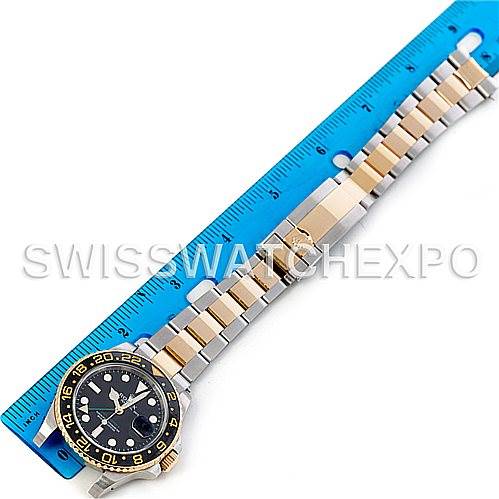 The image shows a Rolex GMT-Master 116713 Men's Stainless Steel Black Dial 116713 Men's Stainless Steel Black Dial watch placed next to a blue ruler, displaying the watch face, bracelet, and clasp.