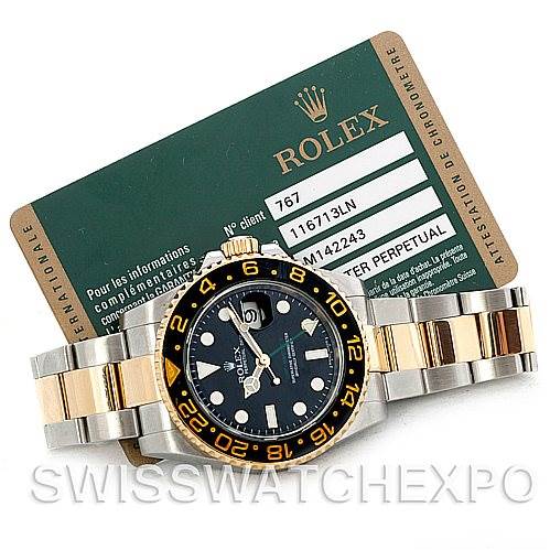 The image shows a top-view angle of a Rolex GMT-Master 116713 Men's Stainless Steel Black Dial 116713 Men's Stainless Steel Black Dial watch with its certification card behind it.
