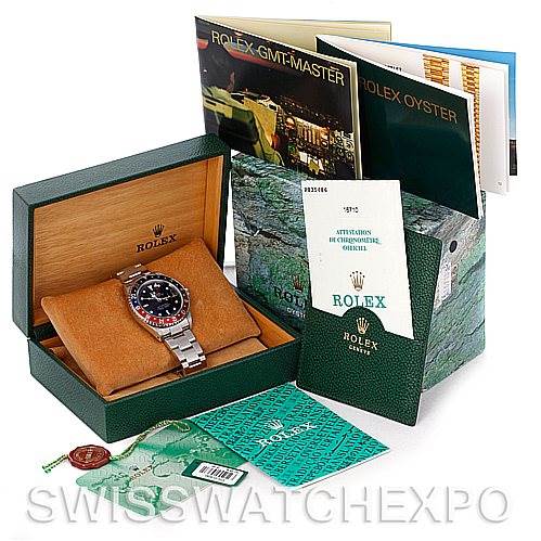 The image shows a Rolex GMT-Master 16710 Men's Stainless Steel Black Dial 16710 Men's Stainless Steel Black Dial watch and accessories, including its box, booklets, warranty card, and tags, displayed from an angled view.