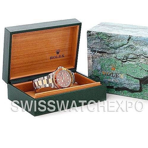 The image shows a Rolex GMT-Master 16713 Men's Stainless Steel Brown Dial 16713 Men's Stainless Steel Brown Dial watch displayed in a green open box with a closed outer box to the side.