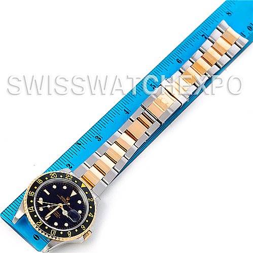 This image shows a top-down view of a Rolex GMT-Master 16713 Men's Stainless Steel Black Dial 16713 Men's Stainless Steel Black Dial watch, focusing on its dial, bezel, and entire bracelet, placed alongside a ruler.
