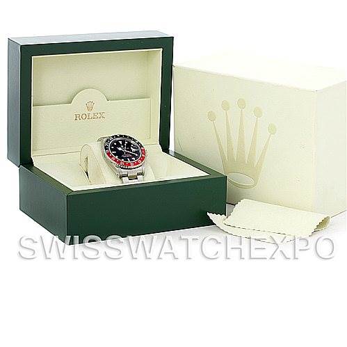 The image shows a Rolex GMT-Master 16710 Men
s Stainless Steel Black Dial 16710 Men
s Stainless Steel Black Dial watch in its opened green box, with an outer box and cleaning cloth beside it.