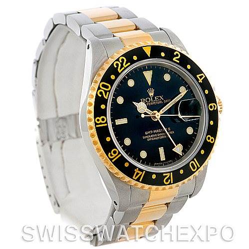 This image shows a Rolex GMT-Master 16713 Men's Stainless Steel Black Dial 16713 Men's Stainless Steel Black Dial watch at a three-quarter angle, highlighting its black dial, two-tone bracelet, and bezel.
