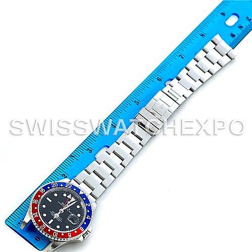 The image shows a Rolex GMT-Master 16710 Men's Stainless Steel Black Dial 16710 Men's Stainless Steel Black Dial watch laid flat against a blue ruler, highlighting its bezel, face, and bracelet.
