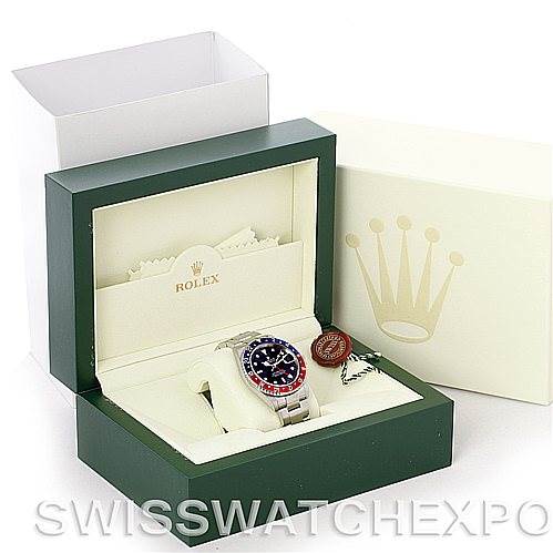 This image shows a Rolex GMT-Master 16710 Men's Stainless Steel Black Dial 16710 Men's Stainless Steel Black Dial watch in an open green Rolex box, with the outer box and papers visible.