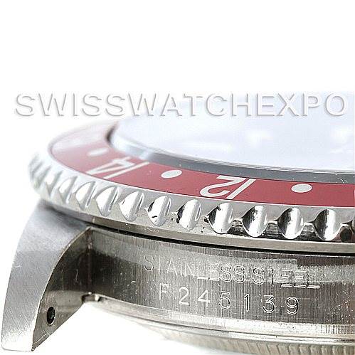This is a close-up side view of the Rolex GMT-Master 16710 Men's Stainless Steel Black Dial 16710 Men's Stainless Steel Black Dial watch showing part of the bezel and the engraved serial number on the case.
