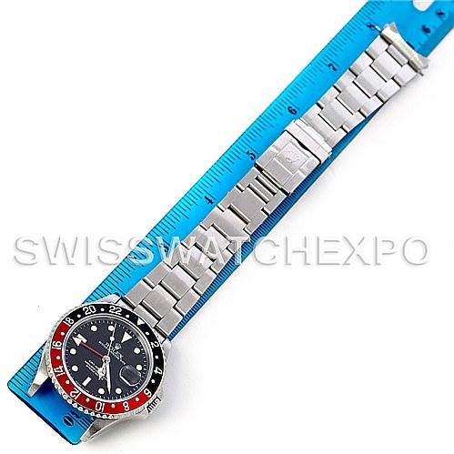The image shows a top-down view of a Rolex GMT-Master 16710 Men's Stainless Steel Black Dial 16710 Men's Stainless Steel Black Dial watch, including the bezel, dial, and metal bracelet against a ruler.