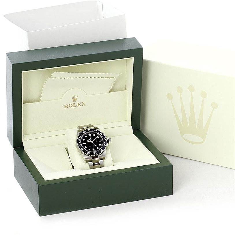 The Rolex GMT-Master 116710 Men's Stainless Steel Black Dial 116710 Men's Stainless Steel Black Dial watch is displayed in its open box, with the watch face and bracelet visible, along with the outer packaging.