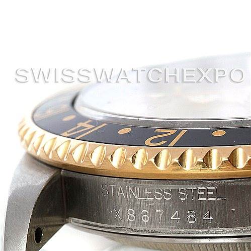 This close-up image of the Rolex GMT-Master 16713 Men's Stainless Steel Champagne Dial 16713 Men's Stainless Steel Champagne Dial shows the stainless steel side, bezel, and part of the case with the serial number.