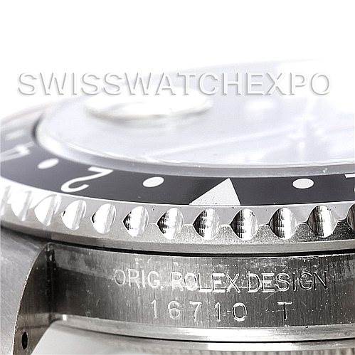 The image shows a close-up of the bezel and case of a Rolex GMT-Master 16710 Men's Stainless Steel Black Dial 16710 Men's Stainless Steel Black Dial model, displaying the serial number and "Orig Rolex Design" engraving.