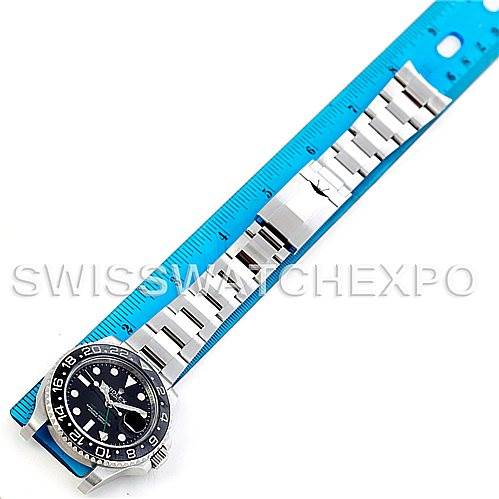 The image shows a Rolex GMT-Master 116710 Men's Stainless Steel Black Dial 116710 Men's Stainless Steel Black Dial watch laid flat next to a blue ruler, displaying the face and entire band.