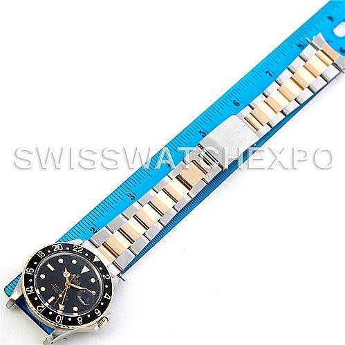 The image shows a Rolex GMT-Master 16753 Men's Stainless Steel Black Dial 16753 Men's Stainless Steel Black Dial watch laid flat next to a blue ruler, highlighting the watch dial, bezel, and bracelet.