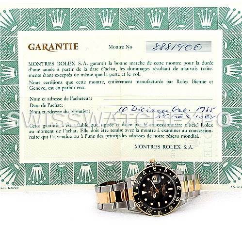 The image shows a Rolex GMT-Master 16753 Men's Stainless Steel Black Dial 16753 Men's Stainless Steel Black Dial watch placed on a warranty certificate viewed from the front, highlighting the face and bracelet.