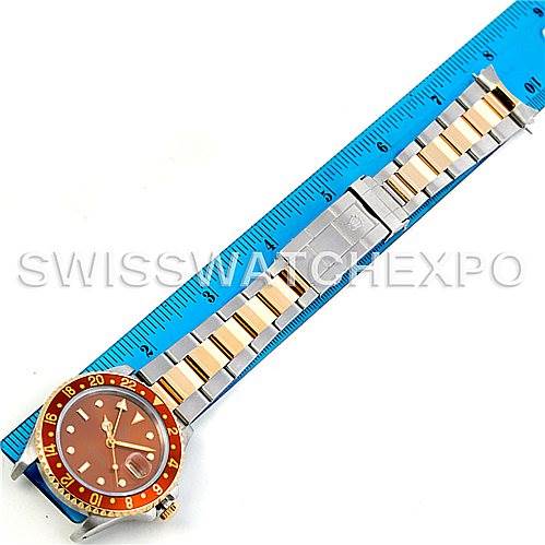 The image shows the Rolex GMT-Master 16713 Men
s Stainless Steel Brown Dial 16713 Men
s Stainless Steel Brown Dial watch laid flat next to a ruler, displaying its bracelet from an overhead angle.