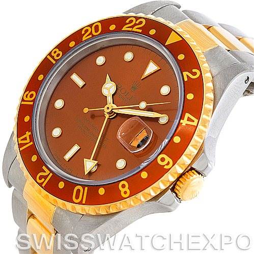 The image shows a close-up view of the Rolex GMT-Master 16713 Men
s Stainless Steel Brown Dial 16713 Men
s Stainless Steel Brown Dial watch, highlighting the face, bezel, crown, and part of the bracelet.