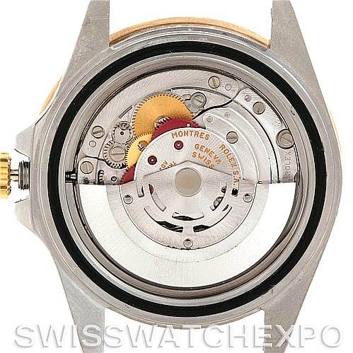 This image shows the internal mechanism of a Rolex GMT-Master 16713 Men
s Stainless Steel Brown Dial 16713 Men
s Stainless Steel Brown Dial watch, focusing on the movement and gears viewed from the back.