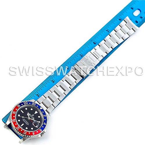 This image shows a top-down view of a Rolex GMT-Master 16710 Men's Stainless Steel Black Dial 16710 Men's Stainless Steel Black Dial watch, highlighting its band, clasp, and bezel, alongside a ruler for scale.