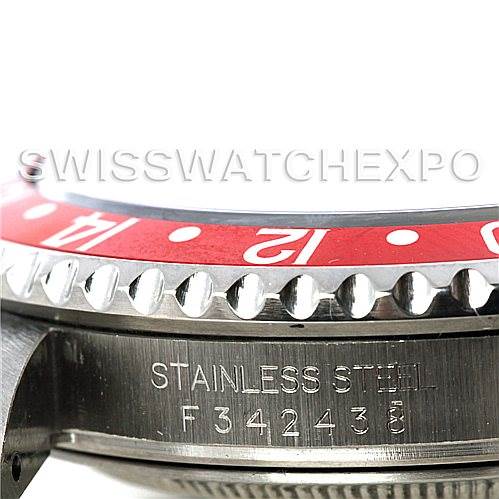 The image shows a close-up of the stainless steel bezel and casing of a Rolex GMT-Master 16710 Men's Stainless Steel Black Dial 16710 Men's Stainless Steel Black Dial watch, highlighting the red bezel and serial number.
