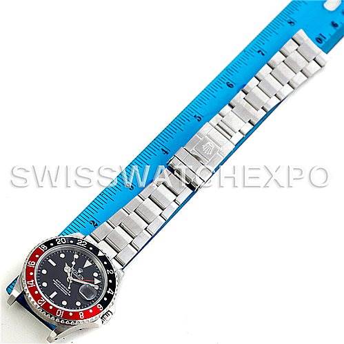 The image shows a Rolex GMT-Master 16710 Men's Stainless Steel Black Dial 16710 Men's Stainless Steel Black Dial watch laid flat with its face and bracelet visible next to a blue ruler.