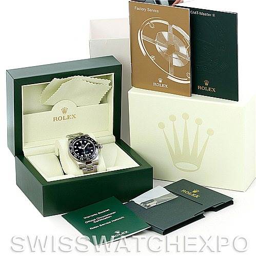 This image shows a Rolex GMT-Master 116710 Men's Stainless Steel Black Dial 116710 Men's Stainless Steel Black Dial watch in a green presentation box, accompanied by various booklets and accessories.