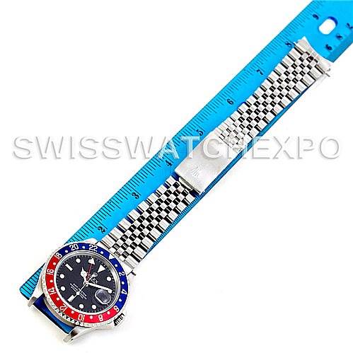 This image shows a top-down view of the Rolex GMT-Master 16700 Men's Stainless Steel Black Dial 16700 Men's Stainless Steel Black Dial watch, highlighting the bezel, dial, and stainless steel bracelet next to a ruler.