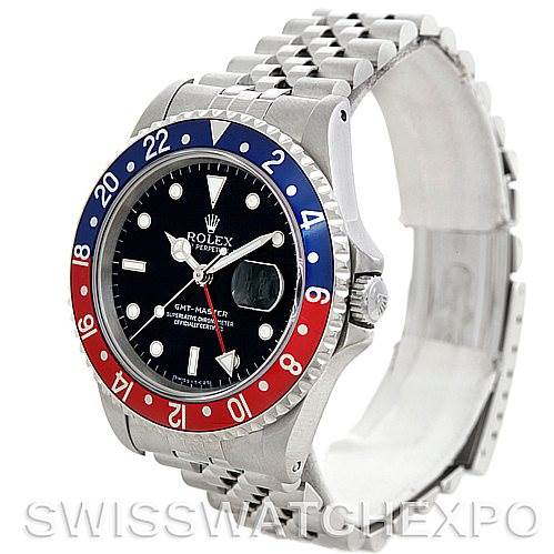 The image shows a side-angle view of a Rolex GMT-Master 16700 Men's Stainless Steel Black Dial 16700 Men's Stainless Steel Black Dial watch, highlighting the black dial, red and blue bezel, and steel bracelet.