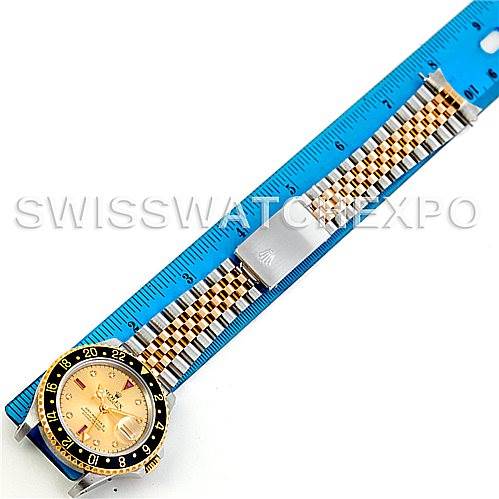 This image shows a Rolex GMT-Master 16713 Men's Stainless Steel Champagne Dial 16713 Men's Stainless Steel Champagne Dial watch placed alongside a blue ruler, highlighting the watch face and band.
