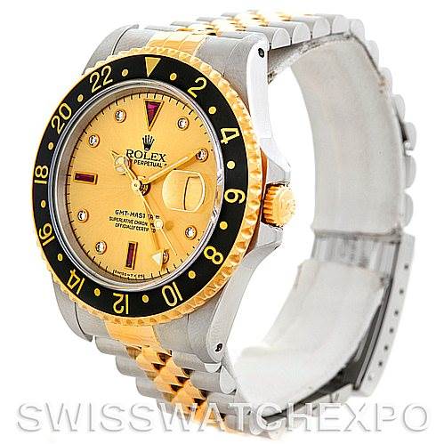 This image shows a Rolex GMT-Master 16713 Men's Stainless Steel Champagne Dial 16713 Men's Stainless Steel Champagne Dial watch angled from the top right, highlighting its gold and black bezel, gold dial, and bi-tone bracelet.