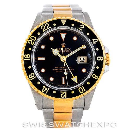 This image shows a Rolex GMT-Master 16713 Men's Stainless Steel Black Dial 16713 Men's Stainless Steel Black Dial watch, displaying its black dial, gold and steel bracelet, and the date window at a frontal angle.
