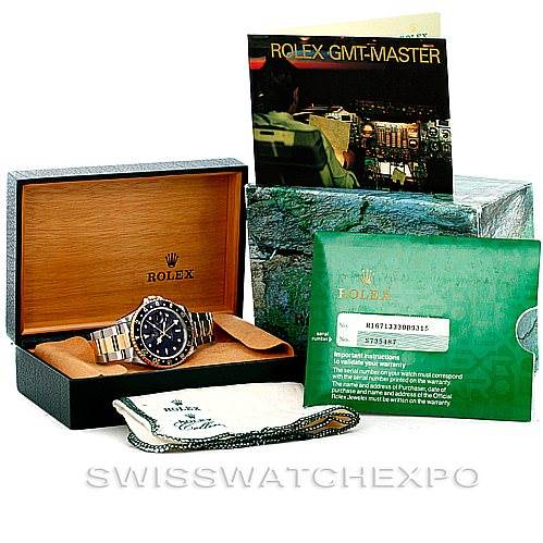 The Rolex GMT-Master 16713 Men's Stainless Steel Black Dial 16713 Men's Stainless Steel Black Dial watch is shown with its box, manual, warranty card, and cleaning cloth.