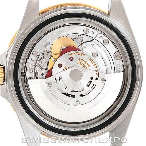 This is a close-up view of the movement inside a Rolex GMT-Master 16713 Men's Stainless Steel Black Dial 16713 Men's Stainless Steel Black Dial, showing gears, rotors, and detailed mechanical parts.