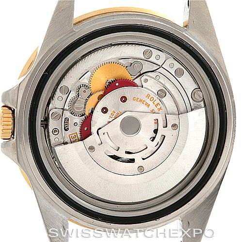 The image shows the internal mechanism of a Rolex GMT-Master 16713 Men's Stainless Steel Black Dial 16713 Men's Stainless Steel Black Dial watch, viewed from the back, revealing the movement and gear components.