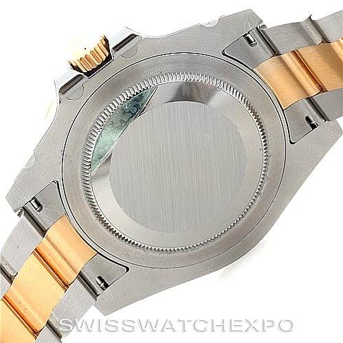 This image shows the underside of a Rolex GMT-Master 116713 Men's Stainless Steel Black Dial 116713 Men's Stainless Steel Black Dial watch case and its two-tone bracelet in steel and gold.