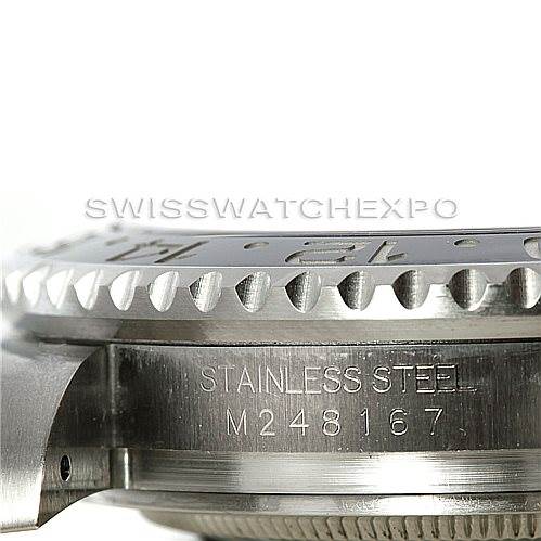 The image shows a close-up side angle view of a Rolex GMT-Master 116710 Men's Stainless Steel Black Dial 116710 Men's Stainless Steel Black Dial watch, highlighting the bezel and part of the stainless steel case with an engraved serial number.