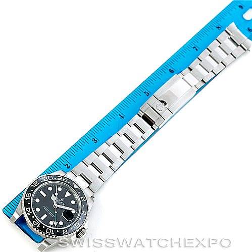 This image shows a top-down view of a Rolex GMT-Master 116710 Men's Stainless Steel Black Dial 116710 Men's Stainless Steel Black Dial watch and its bracelet with a ruler for scale.