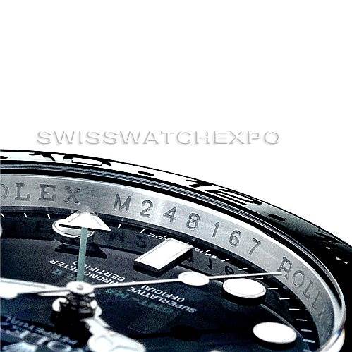 This close-up shows part of the bezel, dial, and serial number engraving of the Rolex GMT-Master 116710 Men's Stainless Steel Black Dial 116710 Men's Stainless Steel Black Dial watch.