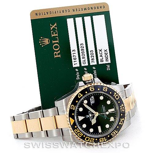 This image shows a Rolex GMT-Master 116713 Men's Stainless Steel Black Dial 116713 Men's Stainless Steel Black Dial watch at an angle, displaying its dial, bezel, two-tone bracelet, and accompanying certification card.